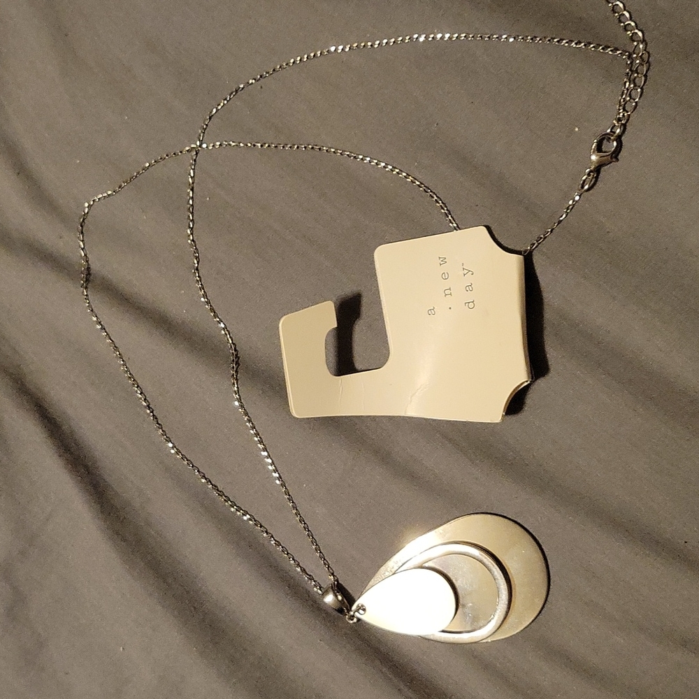 Long silver tone necklace with teardrop charm